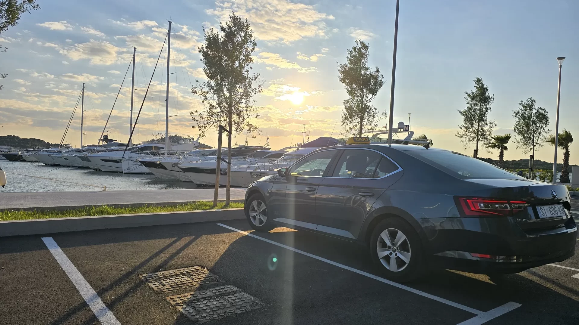TAXI Antonio Škoda Superb at Šibenik marina at sunset, private transfer service for yacht guests